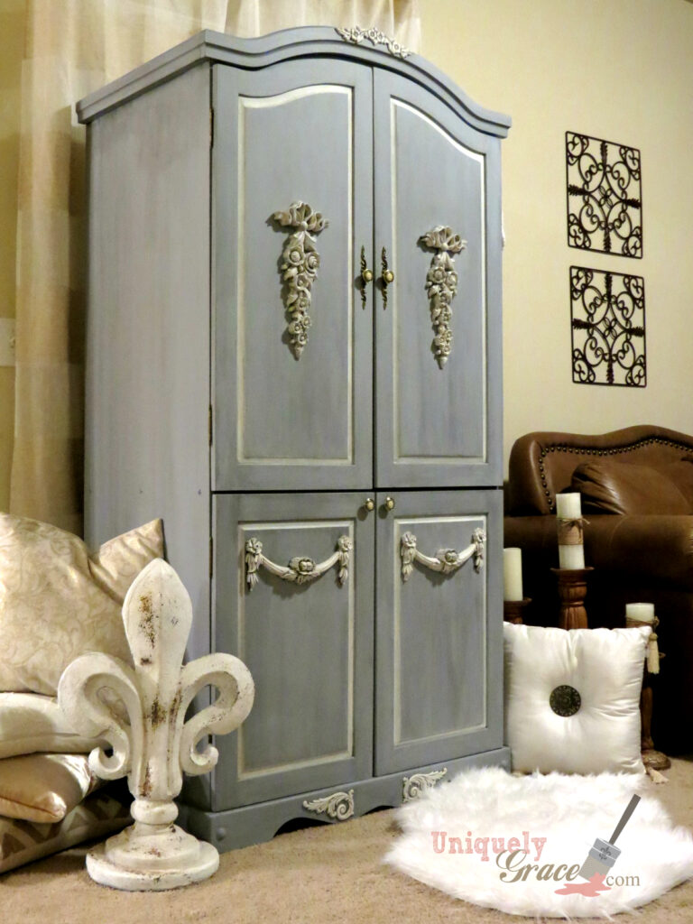 A bluish grey French armoire refinished from a black pine cabinet